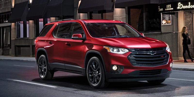 red Chevrolet Traverse running on road