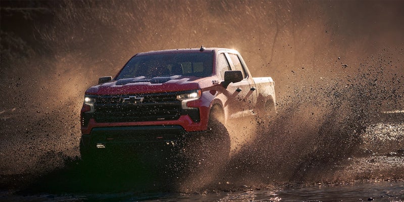 Chevrolet Silverado 1500 running with dust in air